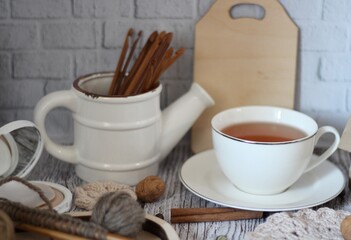 Decorative watering can flower pot crochet hooks collection table different handmade objects on the table woman things hobby craft design beige pastel colors calm cozy photo 