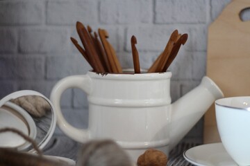 Decorative watering can flower pot crochet hooks collection table different handmade objects on the table woman things hobby craft design beige pastel colors calm cozy photo 