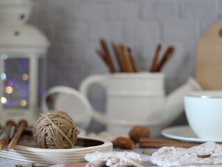 Decorative watering can flower pot crochet hooks collection table different handmade objects on the...