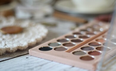 Woman's different things cup of tea, make up, ball clew yarn, mirror doily cozy photo beige pastel...