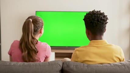 The kid watches green screen TV. generated with ai - Powered by Adobe
