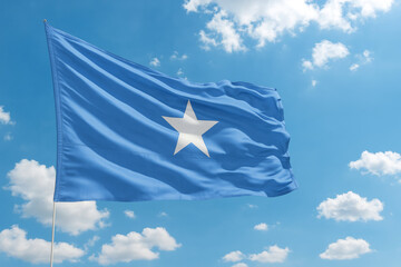 Somalia silk flag waving against clear blue sky during a bright day. Somali flag - the national symbol of Somalia, Somali flag at sunrise
