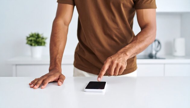 Man using a smartphone in a kitchen