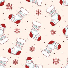 Seamless vector pattern of Christmas stockings with snowflakes in soft red and cream colors. Great for seasonal products and holiday decor.