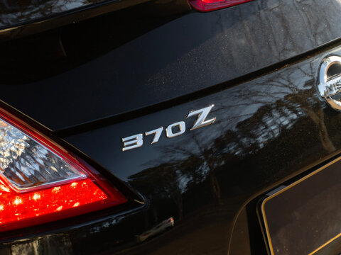 Closeup of the 370Z chrome logo on a black car - Sports car emblem detail