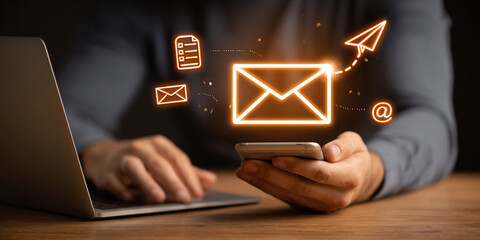 Digital marketer using email marketing tools on laptop and smartphone, sending newsletters and analyzing campaign performance to engage subscribers and grow business through personalized content