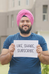 Vertical Photo of Sikh Indian Man Holding Like, Share, Subscribe Poster