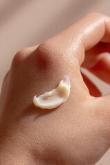 Fototapeta premium Macro close-up of thick beef tallow cream resting on fingertips showing smooth skin hydration natural skincare concept