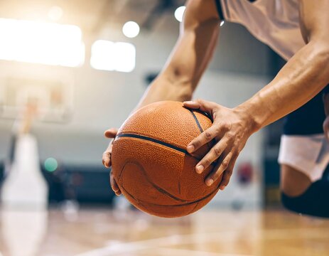 Basketball player holding ball in indoor arena