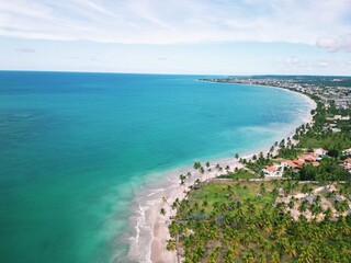 Aerial view from Praia dos Carneiros, Pernambuco: turquoise sea, white sandy beach, endless palm...