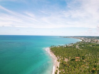 Aerial view from Praia dos Carneiros, Pernambuco: turquoise sea, white sandy beach, endless palm trees and a charming seaside chapel create the perfect tropical paradise in northeast Brazil