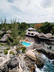 Aerial drone view of the dramatic cliffs of Negril, Jamaica, with turquoise Caribbean waters, lush...