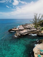 Aerial drone view of the dramatic cliffs of Negril, Jamaica, with turquoise Caribbean waters, lush vegetation, and stunning sunsets, an unforgettable tropical paradise on the island&rsquo;s west coast

