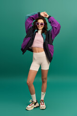 Sporty elegance shines with a stylish young woman on a vibrant turquoise background