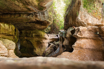 natural rock formation with a narrow stream flowing through it, surrounded by lush greenery at Charco Azul, Puerto Rico