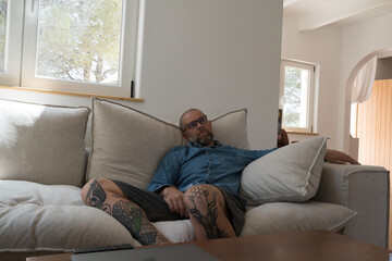 Man relaxing on the sofa at home