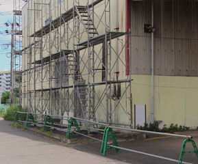 Scaffolding is being built around the building for demolition.