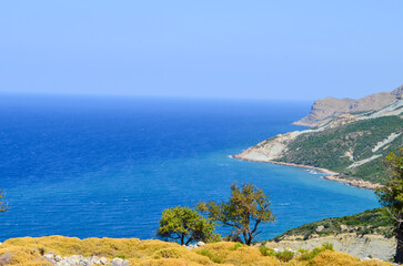 Turquoise Sea and Coastal Cliffs Viewed from a Rocky Hillside