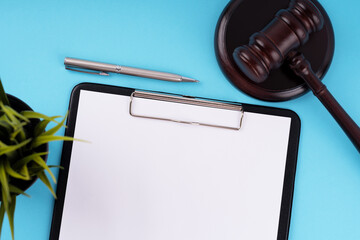 Top view of blank clip board and gavel
