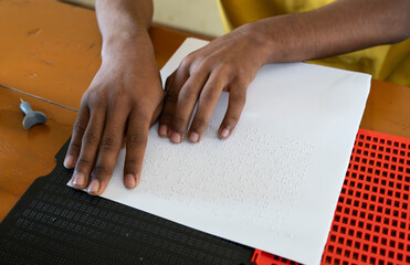Visually impaired students reads using the Braille system