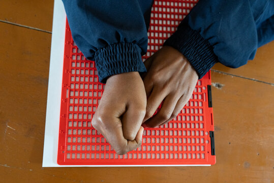 Visually impaired students writes using the Braille system
