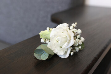 Wedding boutonniere made of roses. Preparation for the wedding.