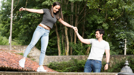 Man helping woman to balance outdoors