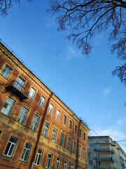 Building with a balcony and a tree in the background