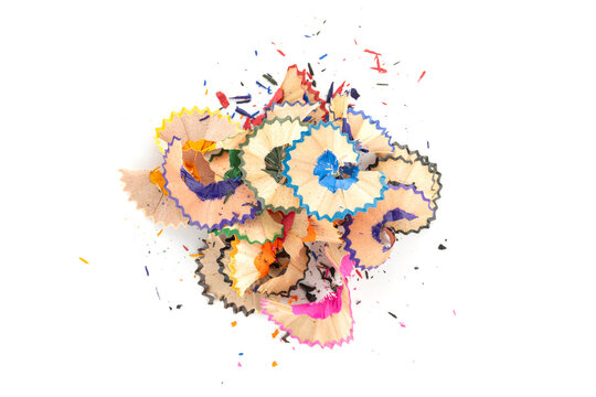 Colorful scattered pencil shavings background. Abstract texture from school art supplies for creative design isolated on white background