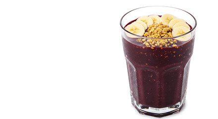 A tall glass of a&ccedil;a&iacute; smoothie topped with banana slices and granola, deep purple color, isolated on a white background