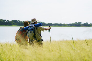 Man and woman are enjoy seeing a beautiful landscape and lake view.