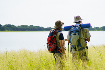Man and woman are enjoy seeing a beautiful landscape and lake view.