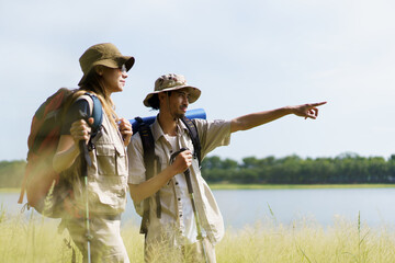 Man and woman are enjoy seeing a beautiful landscape and lake view.