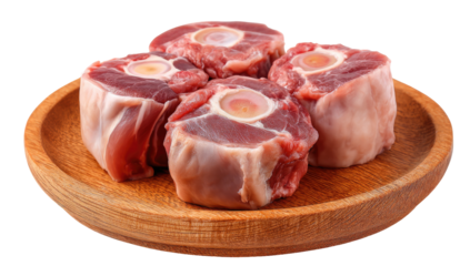 Raw beef oxtails arranged on a wooden plate