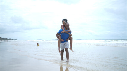 Happy couple enjoying a playful walk on the beach