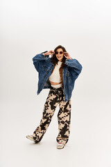 Young stylish woman showcases trendy cow print fashion in a modern studio setting