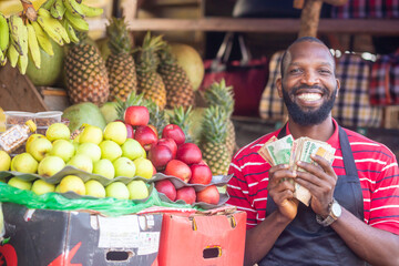 african market man selling fruits items counting money