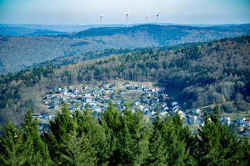 Wind Turbines Overlooking a Forested Hillside Village Panorama
