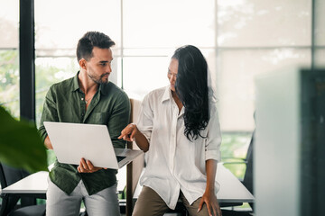 Group of young multi-ethnic startup business team collaborating on project in modern office