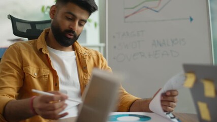 Startup multiracial informal business team three colleagues working at coworking office businessman leader talking checking documents diagrams employees typing laptops diverse group planning teamwork - Powered by Adobe