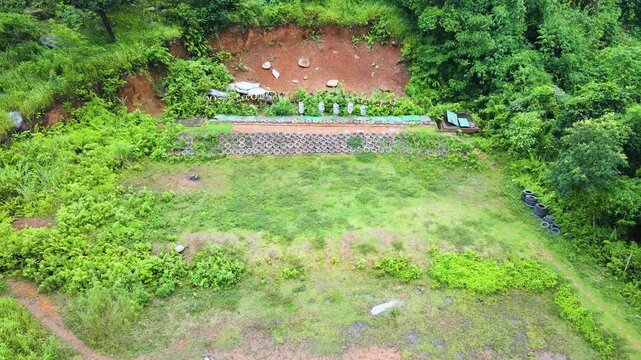 4K Aerial View of a Hillside Organic Garden with Greenery and Farmland
