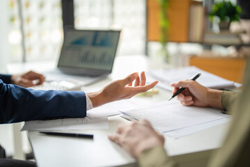 Businessmen working together at desk.