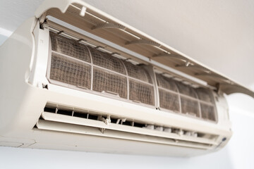 Dirty in dust and mold air conditioner filter close-up. Home air conditioner maintenance