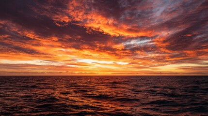 Obraz premium The breathtaking sunset over the ocean with vibrant clouds and tranquil waters.