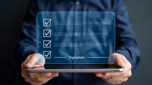 Man holding tablet with digital checklist and signature field, signifying modern business approvals and task completion on a sleek interface