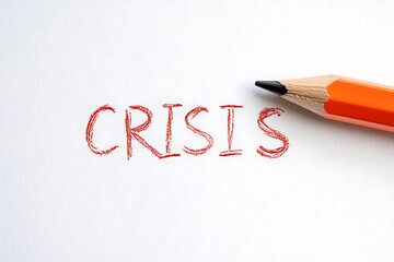 A close-up shot of the word "CRISIS" written in red with a pencil next to it, highlighting a moment of challenge and potential for change.