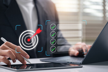 Fototapeta premium Digital goal setting and task management with businesswoman using tablet and laptop to track checklist, plan strategies, and complete targets for improved productivity and business performance