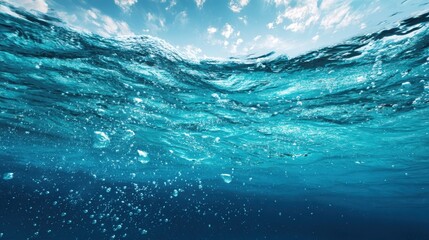 The serene underwater view of waves and bubbles in a clear ocean