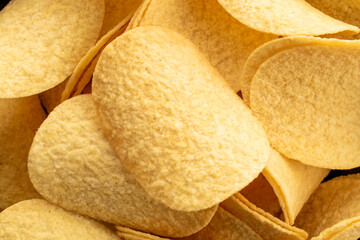 Crispy potato chips, top view, macro.
