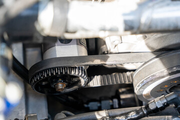 Close-up of timing belt and tensioner pulley in car engine